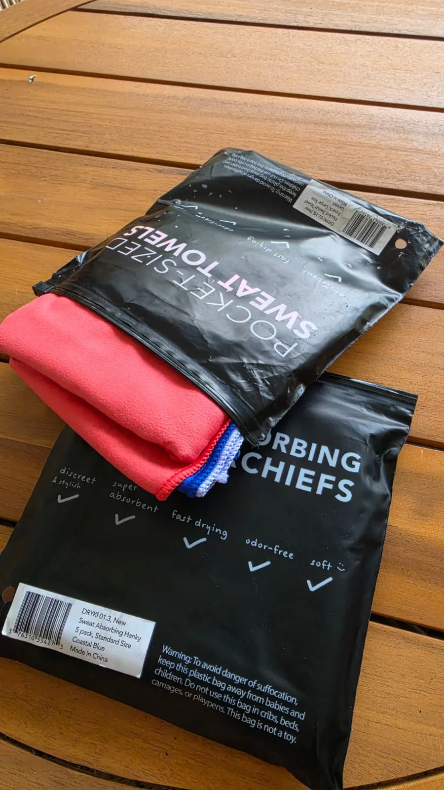 Five-pack standard-size sweat towel package in coastal blue, partly opened on the table.