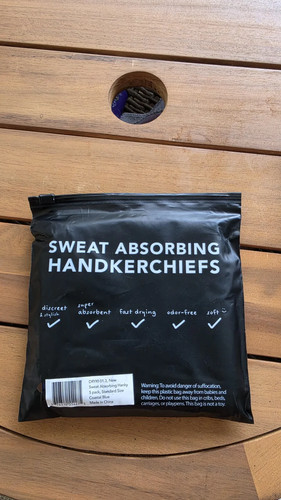 Three-pack large-size sweat towel package in desert packaging, partly opened on the table.